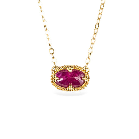 18k yellow gold and ruby gemstone necklace on a white background.