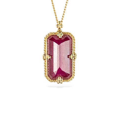 18k yellow gold and ruby gemstone necklace on a white background.