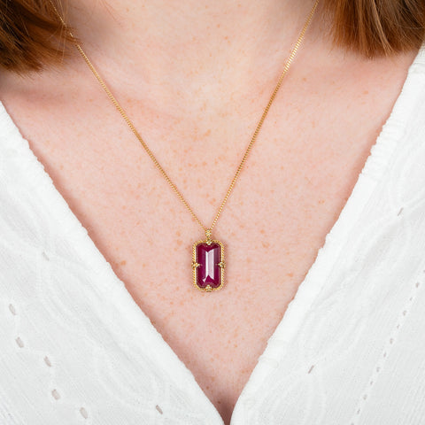 A model wears an 18k yellow gold and ruby necklace.