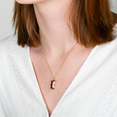 A model wears an 18k yellow gold and ruby necklace.