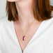 A model wears an 18k yellow gold and ruby necklace.