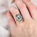 Dark rectangular snakeskin agate ring on am odel
