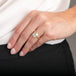 A model wears an 18k yellow gold and silver diamond ring with a business casual outfit.