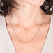 Close up of silver diamond textile necklace on a model