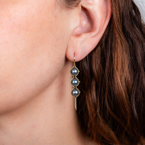 Blue akoya pearl earrings on model