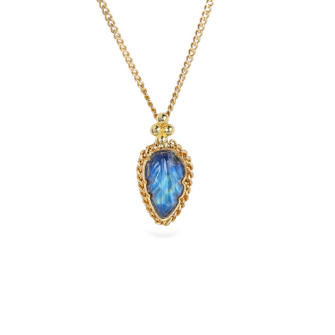 Gold necklace with a carved moonstone pendant in the shape of a tiny leaf on a white background