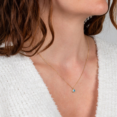 Tiny opal heart necklace on model