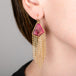 A person wears Handmade tourmaline earrings with 18k gold chain tassels