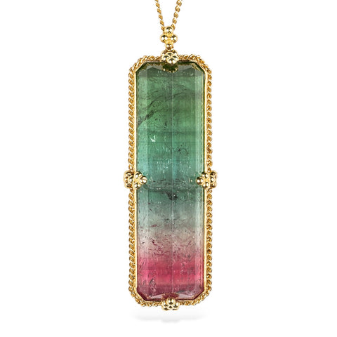 18k yellow gold and watermelon tourmaline gemstone necklace on a white background.