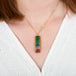 A model wears a watermelon tourmaline and 18k yellow gold necklace.