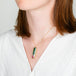 A model wears a watermelon tourmaline and 18k yellow gold necklace.