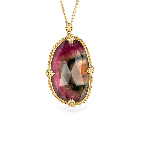 18k yellow gold and watermelon tourmaline gemstone necklace on a white background.