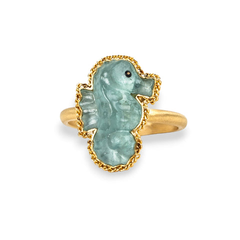 Aquamarine seahorse ring in 18K yellow gold, hand-carved from the tranquillizing gemstone. Set in a meticulously handmade gold frame with braided gold detail. 