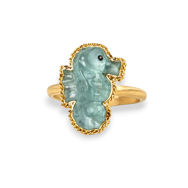 Aquamarine seahorse ring in 18K yellow gold, hand-carved from the tranquillizing gemstone. Set in a meticulously handmade gold frame with braided gold detail.