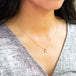 A close up of a heart-shaped Diamond pendant suspended from an 18K yellow gold chain. Handmade gold bezel with braided detail and granulation. Handmade in New York.
