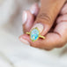 Elevate your style with this Ethiopian Opal ring in 18K yellow gold, featuring a stunning display of colorful confetti. Handmade gold frame showcases braided detail and granulation. Handmade in New York.