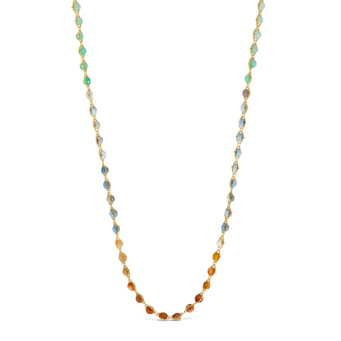 A long woven 18k yellow gold necklace features shades of mixed opals in burnt orange, teal, and periwinkle. The stone beads are woven delicately between two chains. 