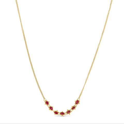 This delicate 18k yellow gold necklace features a row of seven woven ruby beads in the center. The necklace is finished with a lobster clasp closure