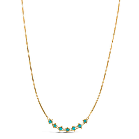 This delicate 18k yellow gold necklace features a row of seven woven turquoise beads in the center. The necklace is finished with a lobster clasp closure