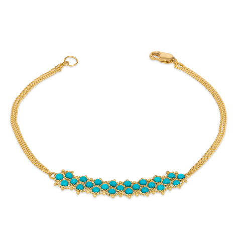 This delicate 18k yellow gold chain bracelet features three rows of woven turquoise beads in the center. The bracelet is finished with a lobster clasp closure.