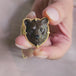 A video of a necklace featuring a jasper gemstone carved into a grizzly bear 18k yellow gold bezel and matching chain.