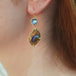 A video featuring Yowah nut opal and moonstone earrings set in 18k gold.