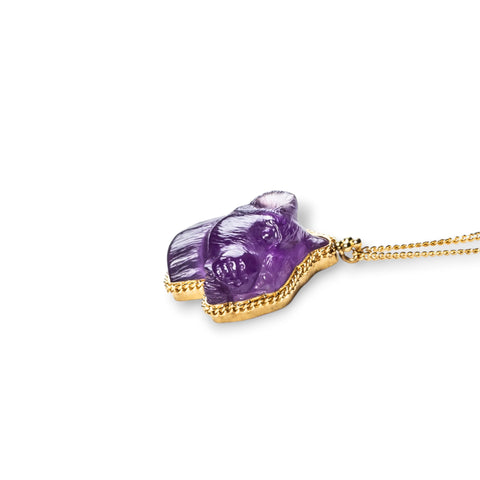 An amethyst panther pendant on an 18K yellow gold chain. Handmade gold bezel showcases intricate braided detail.