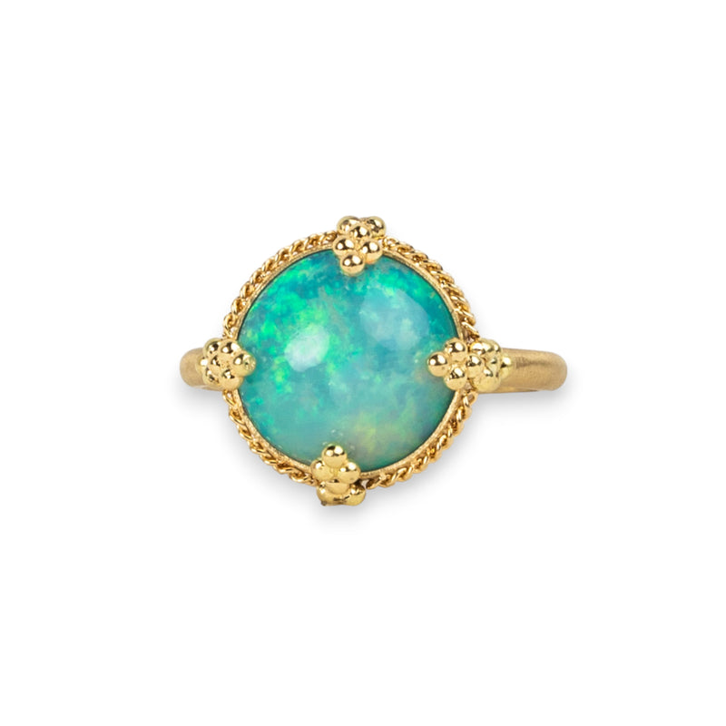 Ethiopian Opal ring in 18K yellow gold, featuring bold flashes of electric green and neon yellow amidst sparkling turquoise. Meticulously handmade gold frame with braided gold and granulated prongs.