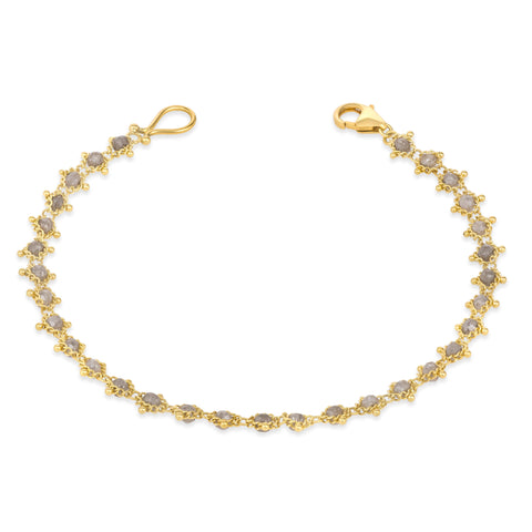 This 18k yellow gold bracelet features silver diamond beads woven throughout a delicate chain. The bracelet features a lobster clasp closure.