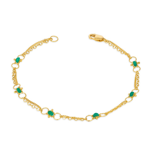 This delicate 18k yellow gold chain bracelet is dotted with green emerald beads throughout. The bracelet is finished with a lobster clasp closure.