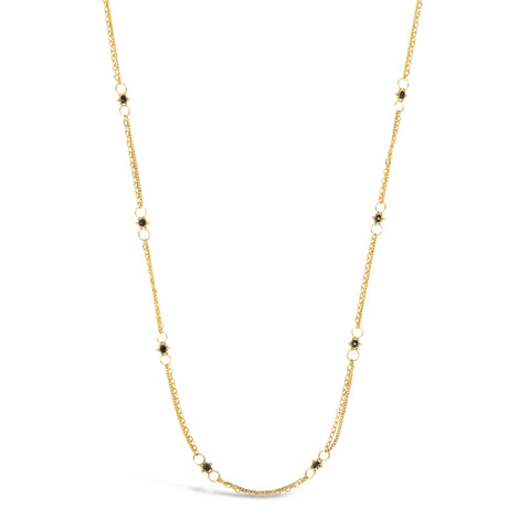This delicate 18k yellow gold chain necklace is dotted with black diamond beads throughout. The necklace is finished with a lobster clasp closure.