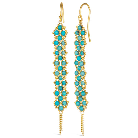 A pair of long turquoise earrings features a woven lattice pattern and two dangling chains at the bottom of the earring. The earrings fasten with french hook closures.