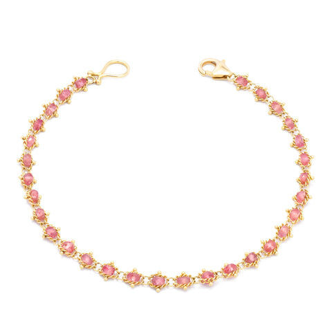 An 18k yellow gold chain bracelet with a row of small Spinel gemstone beads. Finished with a gold lobster clasp.