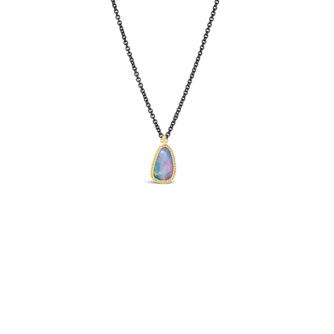 Small 18k yellow gold and opal pendant on an oxidized sterling silver chain on a white background.