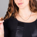 A model wears a short black diamond and 18k yellow gold station necklace set in an oxidized sterling silver chain.
