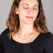 A model wears a short oxidized sterling silver chain with blue diamond and 18k yellow gold stations throughout.