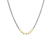 A short necklace that is crafted with 18k yellow gold wrapped silver diamonds in the center of an oxidized sterling silver chain.