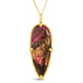 This teardrop shaped floral and leaf carved tourmaline is set in an 18k yellow gold chain wrapped bezel with four beaded prongs. The pendant hangs on a delicate chain.