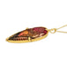 This teardrop shaped floral and leaf carved tourmaline is set in an 18k yellow gold chain wrapped bezel with four beaded prongs. The pendant hangs on a delicate chain.