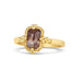 A rectangular faceted champagne diamond is set in an 18k yellow gold chain wrapped bezel with four beaded prongs on a thin band.