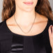 A model wears a short necklace with 18k yellow gold wrapped silver diamonds set in the center of an oxidized sterling silver chain.