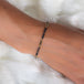 This oxidized sterling silver chain bracelet has three black diamond and 18k yellow gold bars stationed throughout.