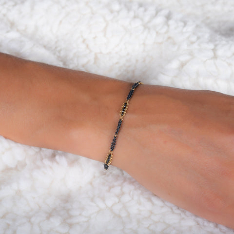 This oxidized sterling silver chain bracelet has three black diamond and 18k yellow gold bars stationed throughout.