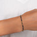 This oxidized sterling silver chain bracelet has three black diamond and 18k yellow gold bars stationed throughout.