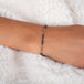 This oxidized sterling silver chain bracelet has three champagne diamond and 18k yellow gold bars stationed throughout.