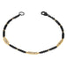 This oxidized sterling silver chain bracelet has three silver diamond and 18k yellow gold bars stationed throughout.