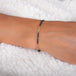 This oxidized sterling silver chain bracelet has three silver diamond and 18k yellow gold bars stationed throughout.
