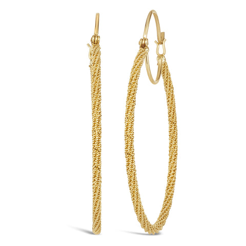 A pair of large stardust textured hoop earrings are crafted in 18k yellow gold