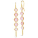 A pair of long 18k yellow gold earrings are crafted with graduated pink opals suspended in delicate chain. The earrings are fastened with French hook closures.