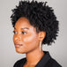 A model wears a long graduated pearl earring suspended in 18k yellow gold chain.